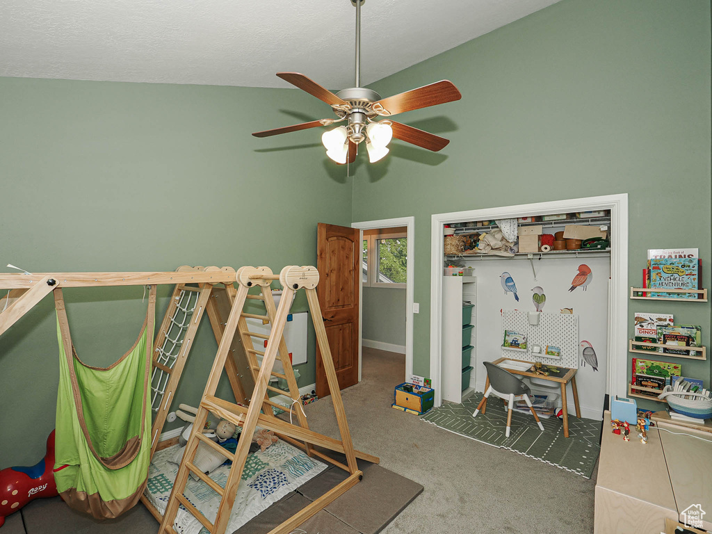 Carpeted bedroom with a closet, baseboards, and a ceiling fan
