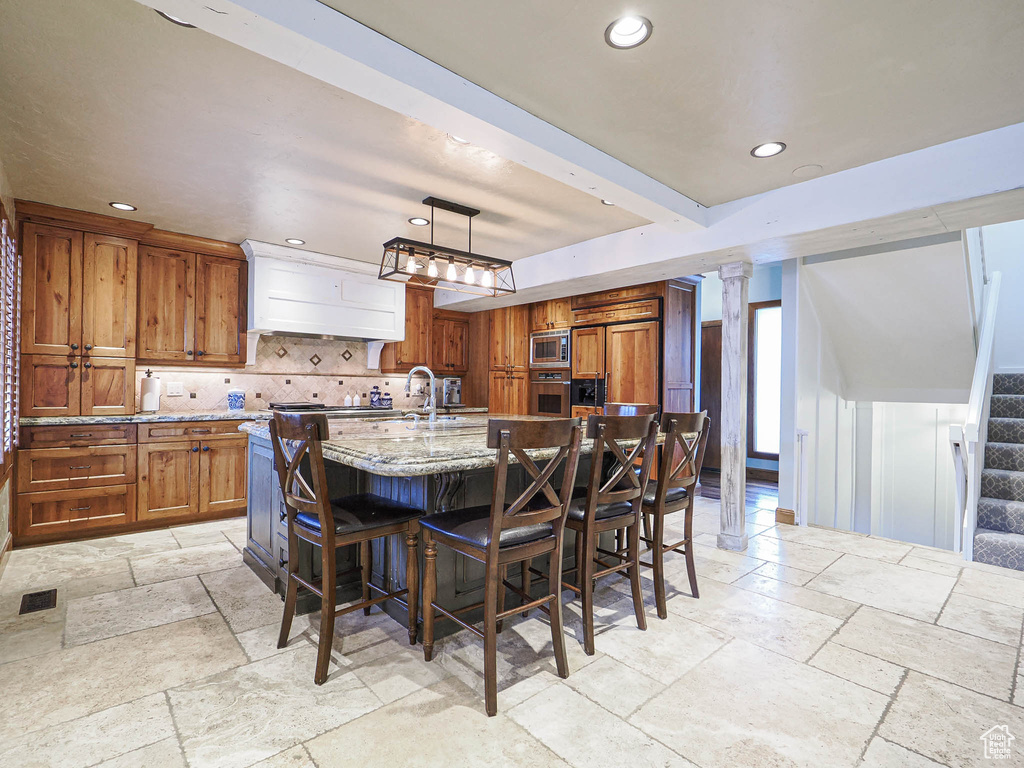 Dining space with stone tile floors, recessed lighting, visible vents, and stairway