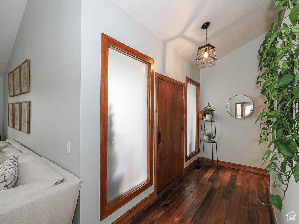 Entryway with baseboards and dark wood-style floors