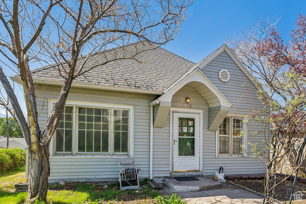View of front of home featuring roof with shingles