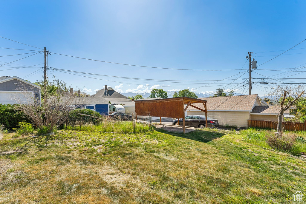 View of yard with fence and a detached carport
