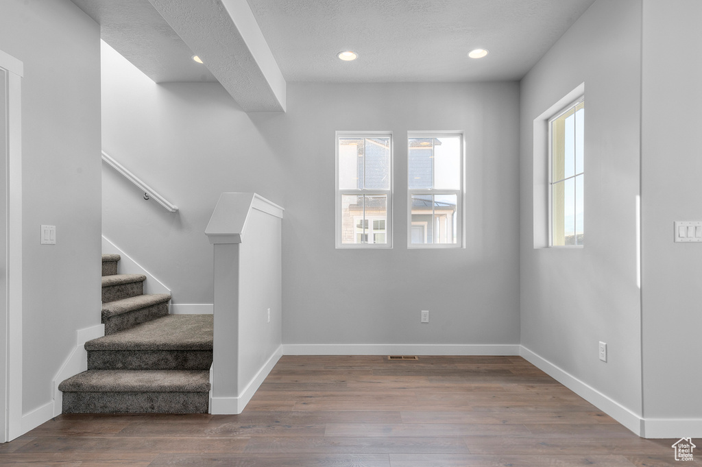Stairs with baseboards, recessed lighting, and wood finished floors
