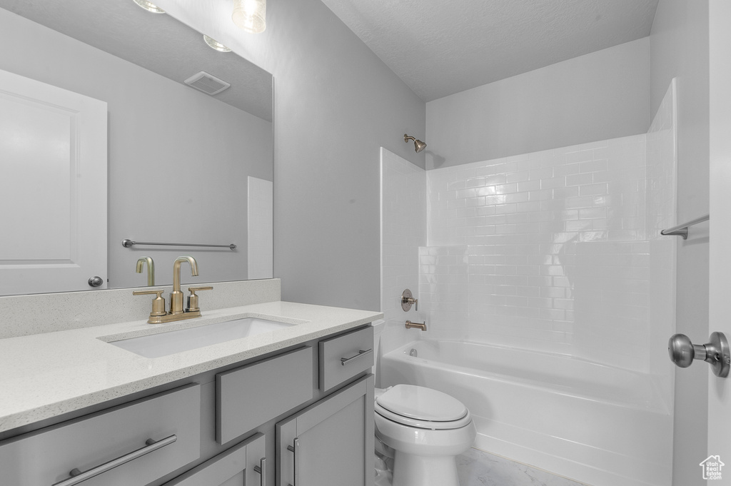Bathroom featuring visible vents, shower / bathing tub combination, toilet, and vanity