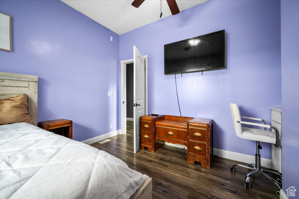 Bedroom featuring baseboards, a ceiling fan, and wood finished floors