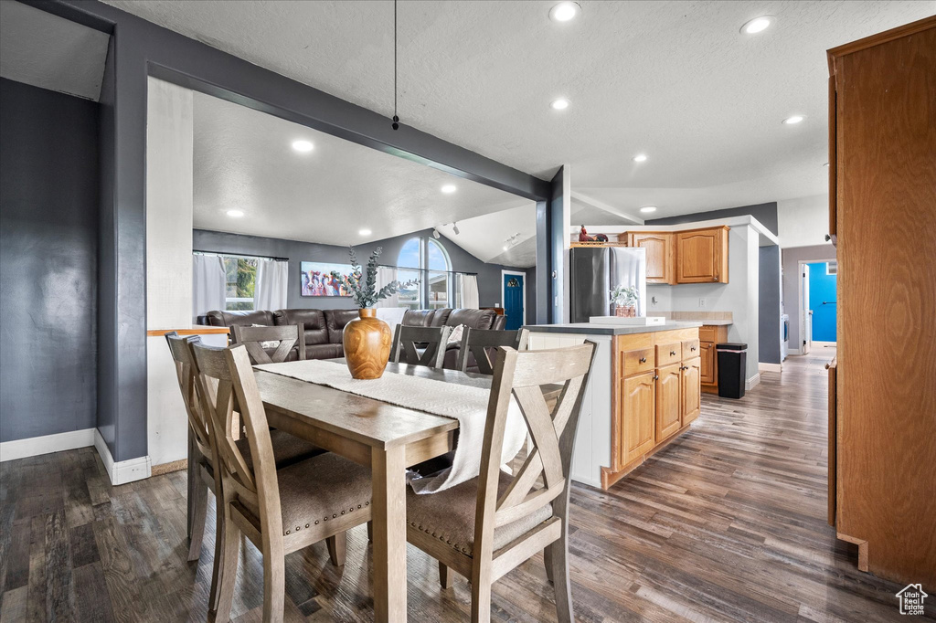 Dining area featuring baseboards, dark wood-style flooring, recessed lighting, and a textured ceiling