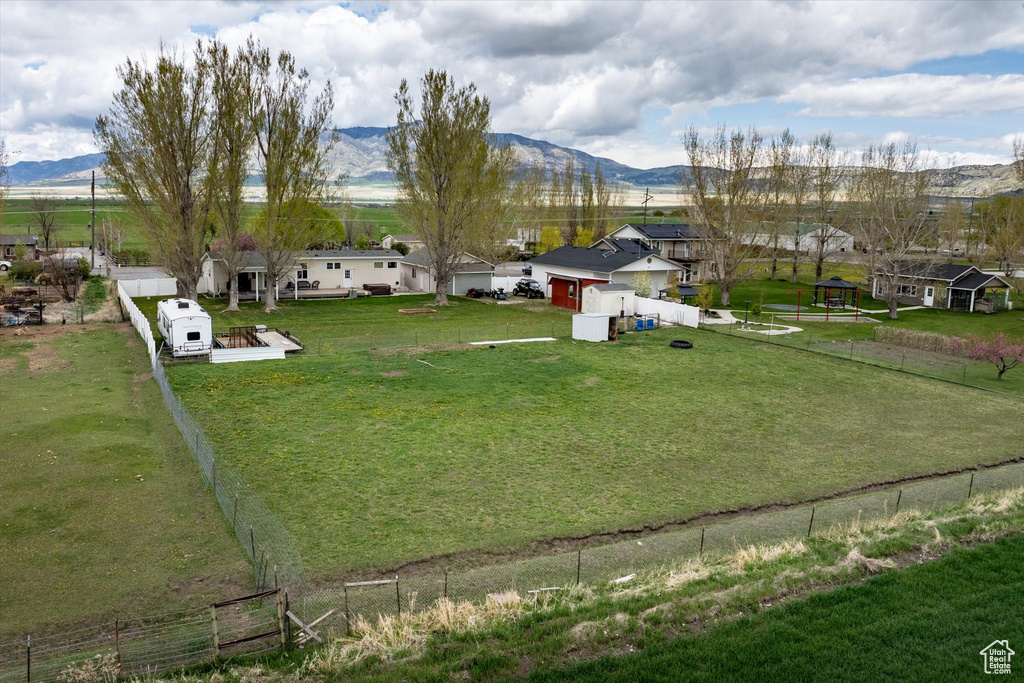 View of yard featuring fence and a mountain view