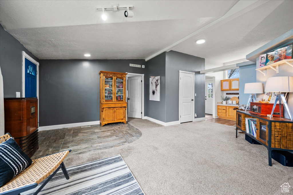 Sitting room featuring baseboards, carpet flooring, vaulted ceiling, and recessed lighting