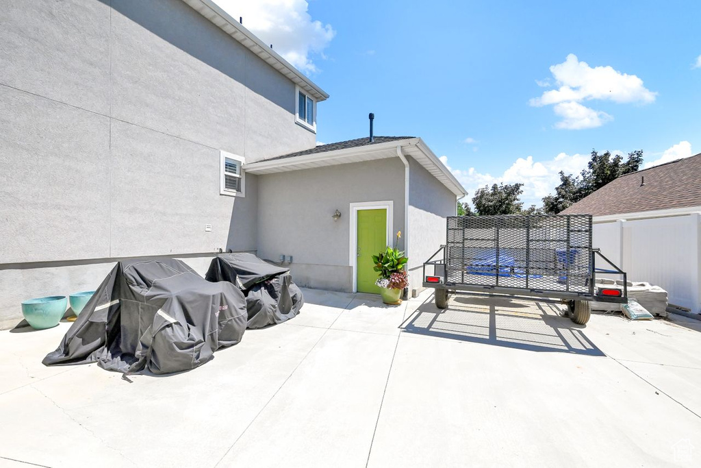 View of patio featuring fence