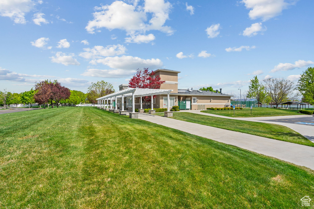 Exterior space featuring a pergola and a front yard