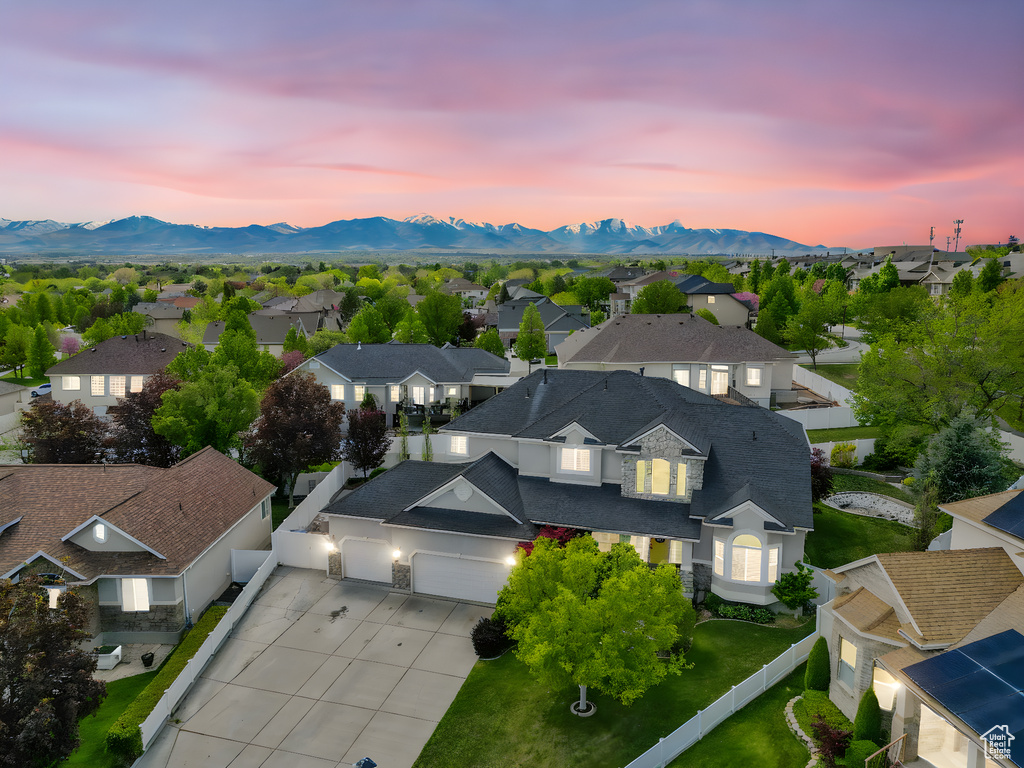 Aerial view at dusk featuring a residential view and a mountain view