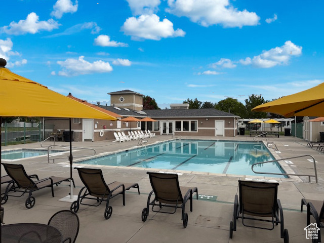 Community pool featuring a patio
