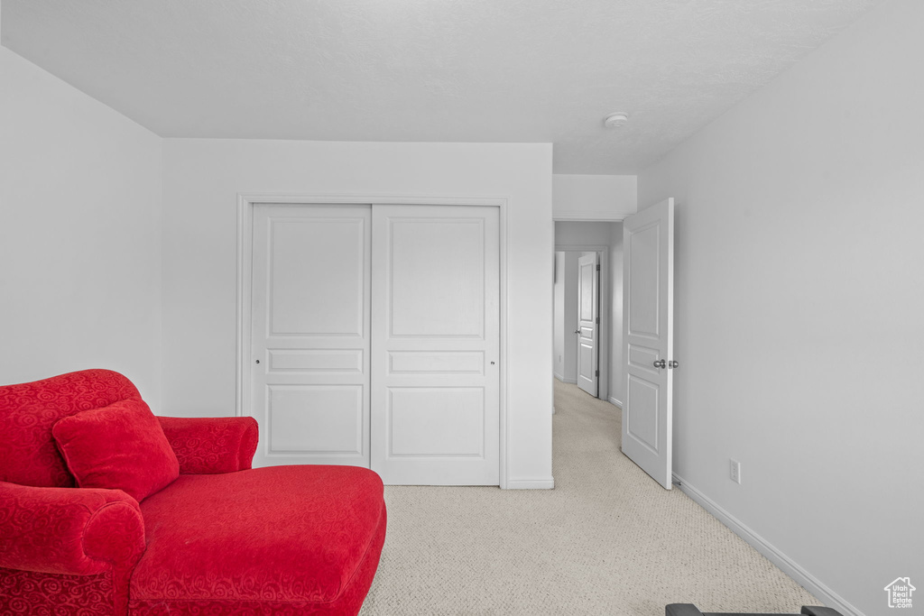 Sitting room featuring baseboards and light colored carpet