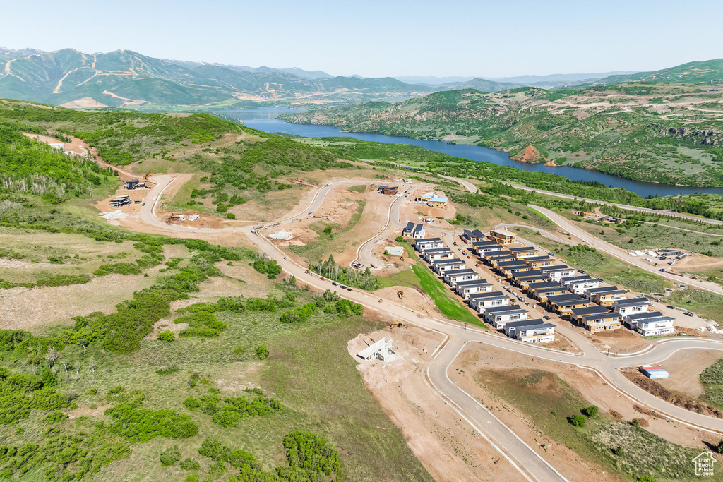 Birds eye view of property featuring a water and mountain view