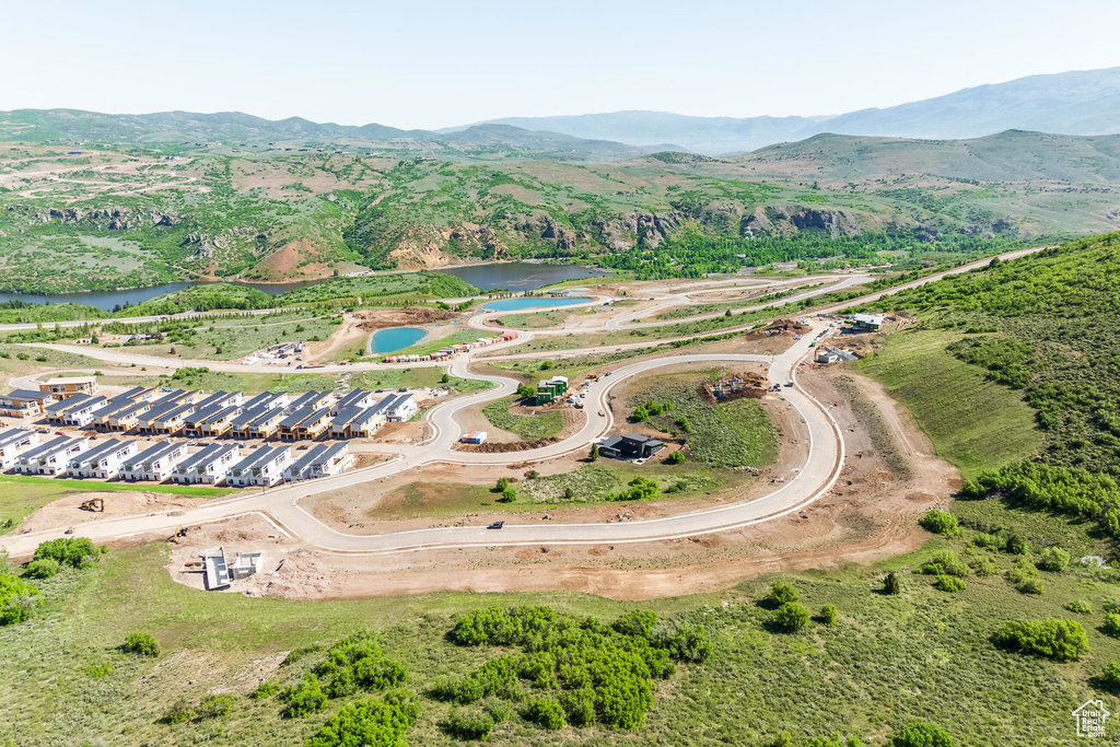Birds eye view of property featuring a water and mountain view