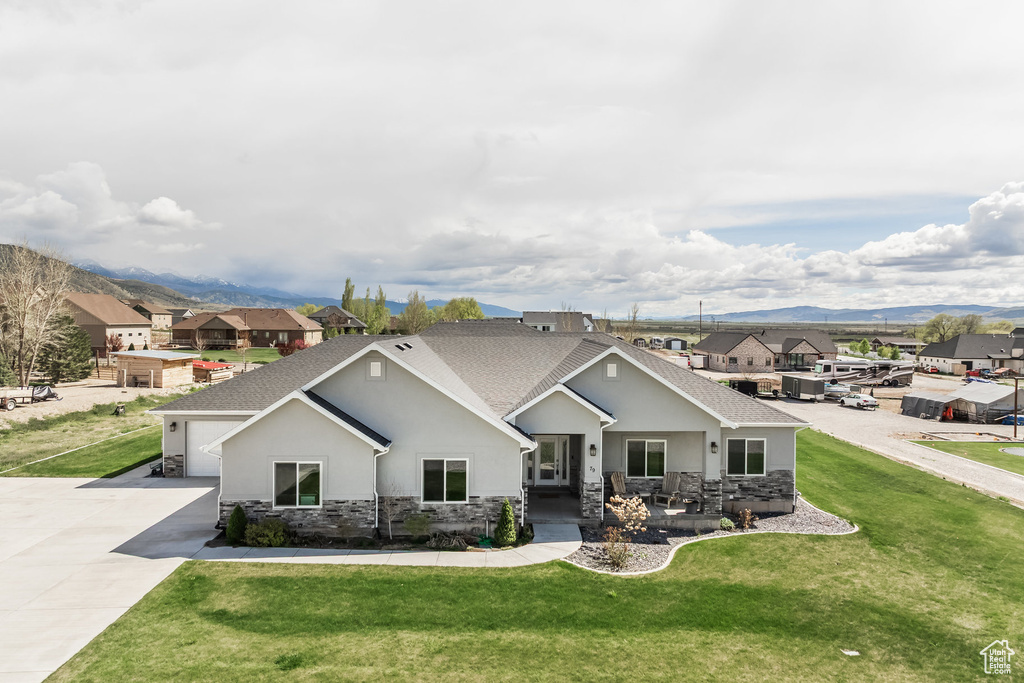 Craftsman inspired home with a mountain view, stucco siding, and stone siding