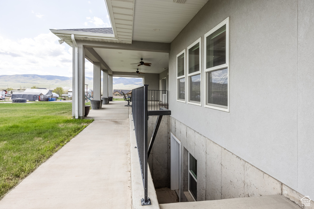 View of patio / terrace featuring ceiling fan and a mountain view