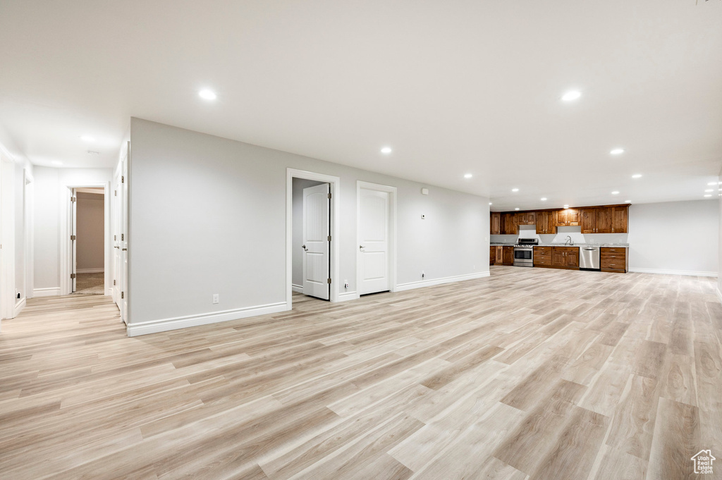 Unfurnished living room featuring recessed lighting, baseboards, and light wood finished floors