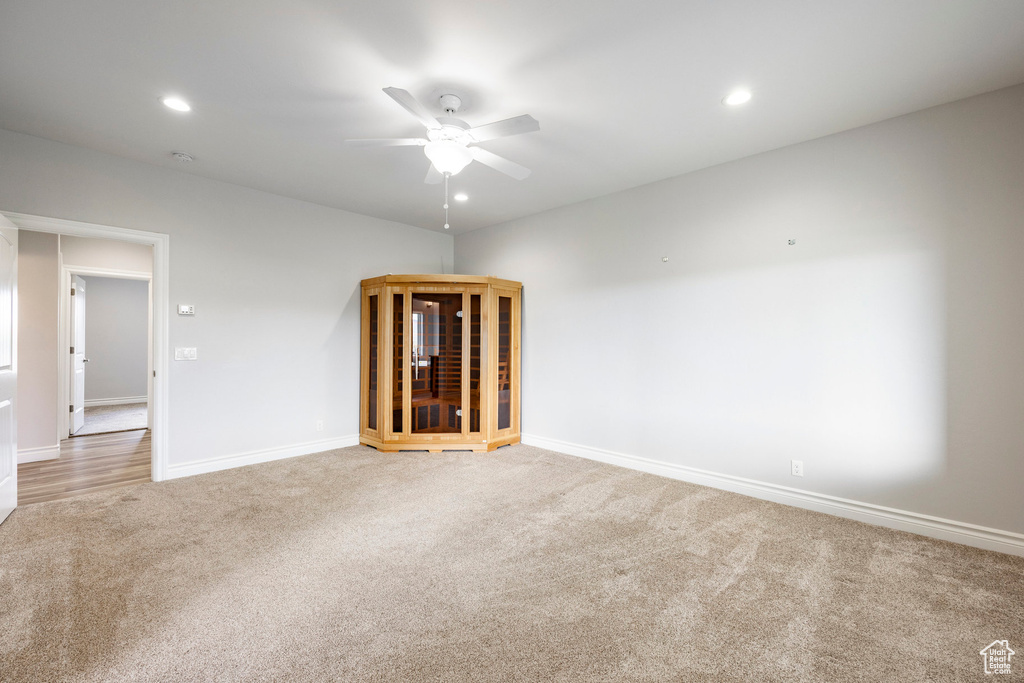 Carpeted spare room with baseboards, a ceiling fan, and recessed lighting