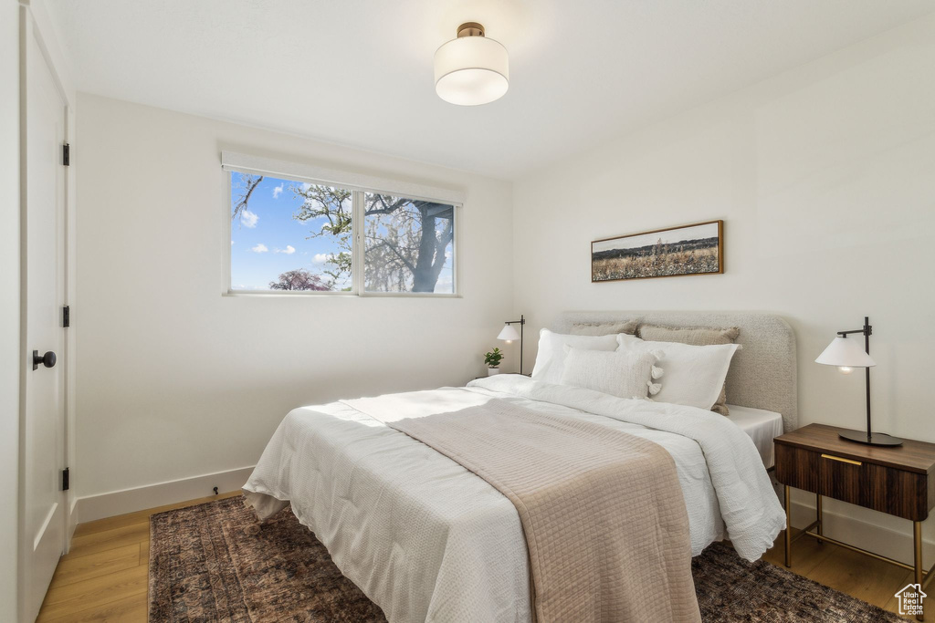 Bedroom with light wood-style floors and baseboards