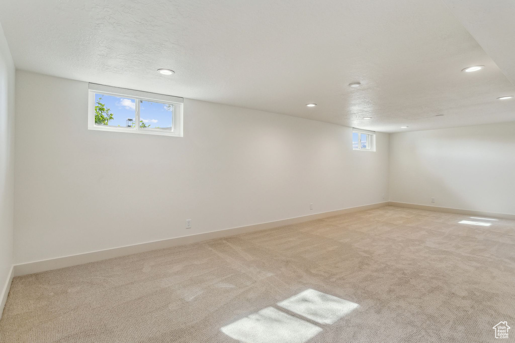 Below grade area featuring recessed lighting, baseboards, and light carpet