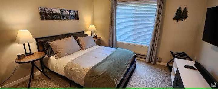 Carpeted bedroom with baseboards