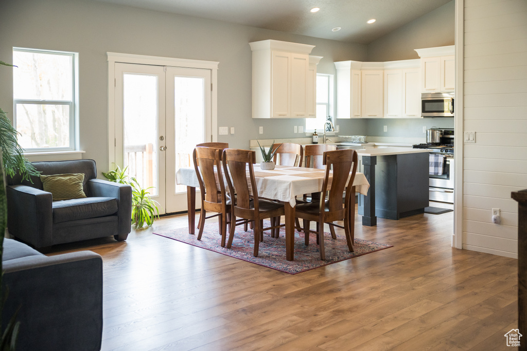 Dining area featuring recessed lighting, wood finished floors, vaulted ceiling, and french doors
