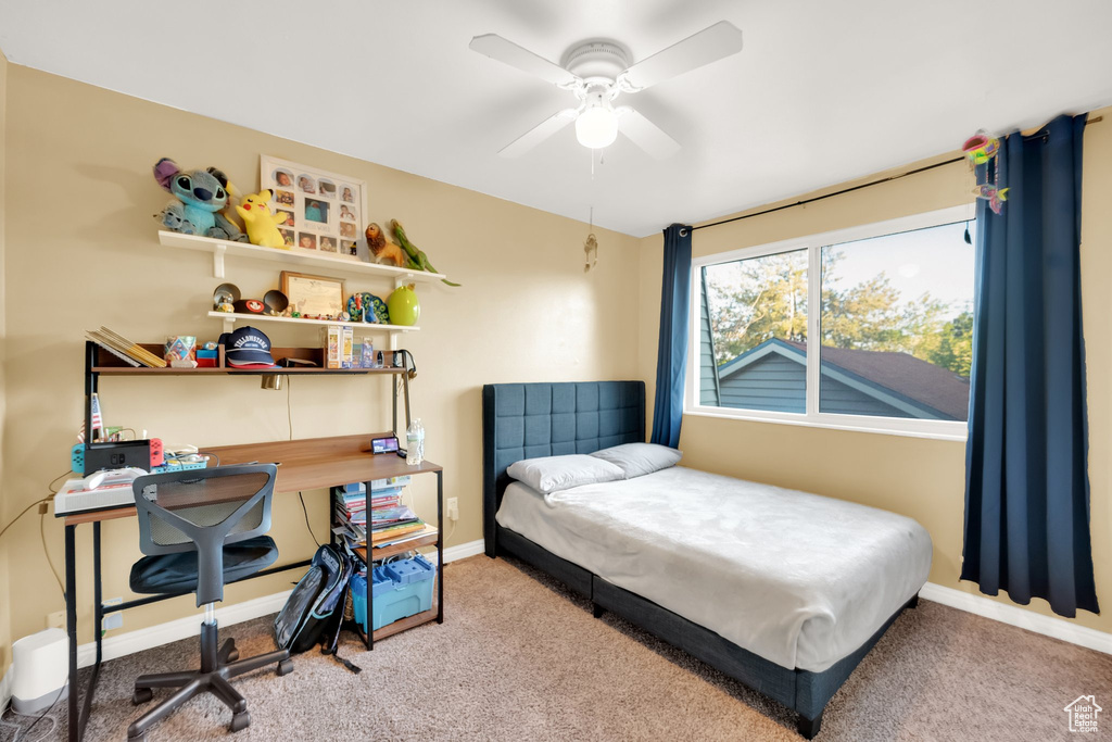 Carpeted bedroom with baseboards and ceiling fan
