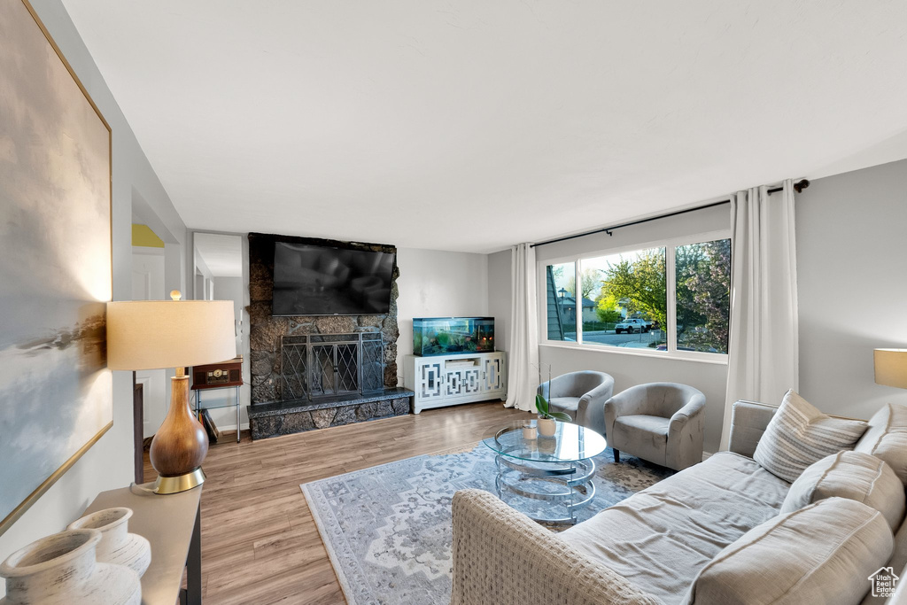 Living room with wood finished floors and a fireplace