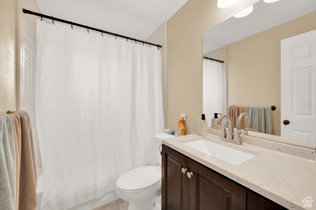 Bathroom featuring vanity, tile patterned floors, and toilet