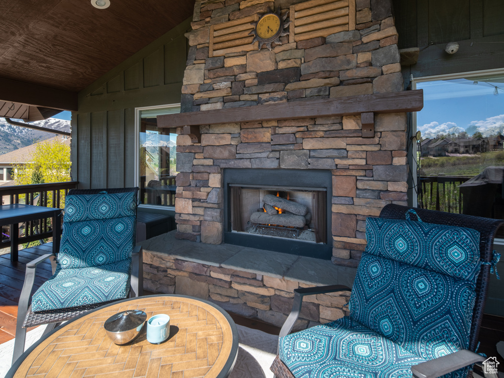 View of patio featuring an outdoor stone fireplace