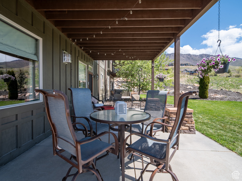 View of patio featuring a mountain view and outdoor dining space
