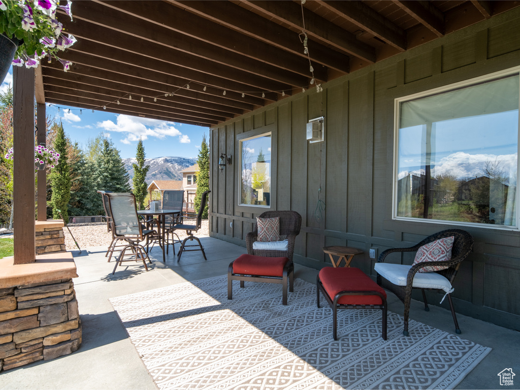 View of patio / terrace featuring a mountain view and outdoor dining space