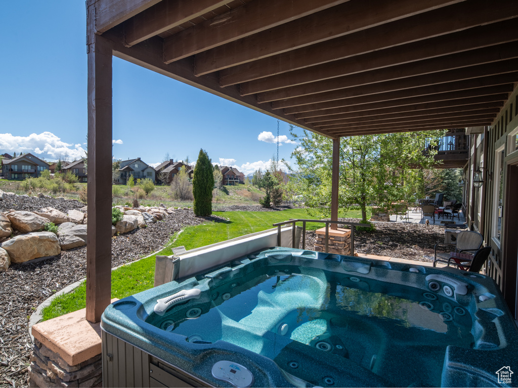 View of swimming pool with a hot tub and a residential view