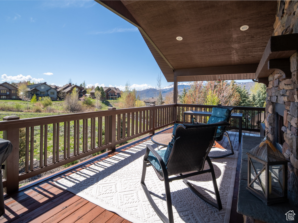 Wooden terrace featuring a residential view and a mountain view