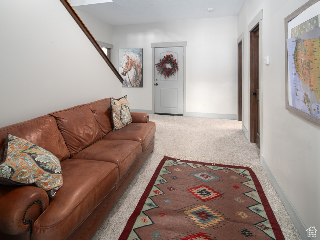 Living room featuring carpet flooring and baseboards