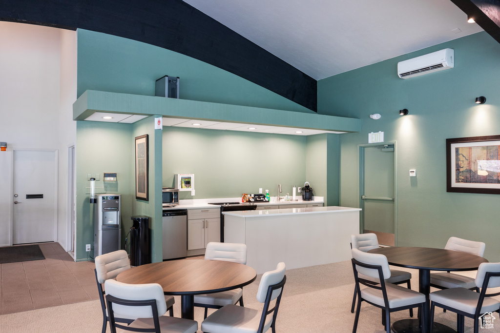 Dining area with an AC wall unit and high vaulted ceiling