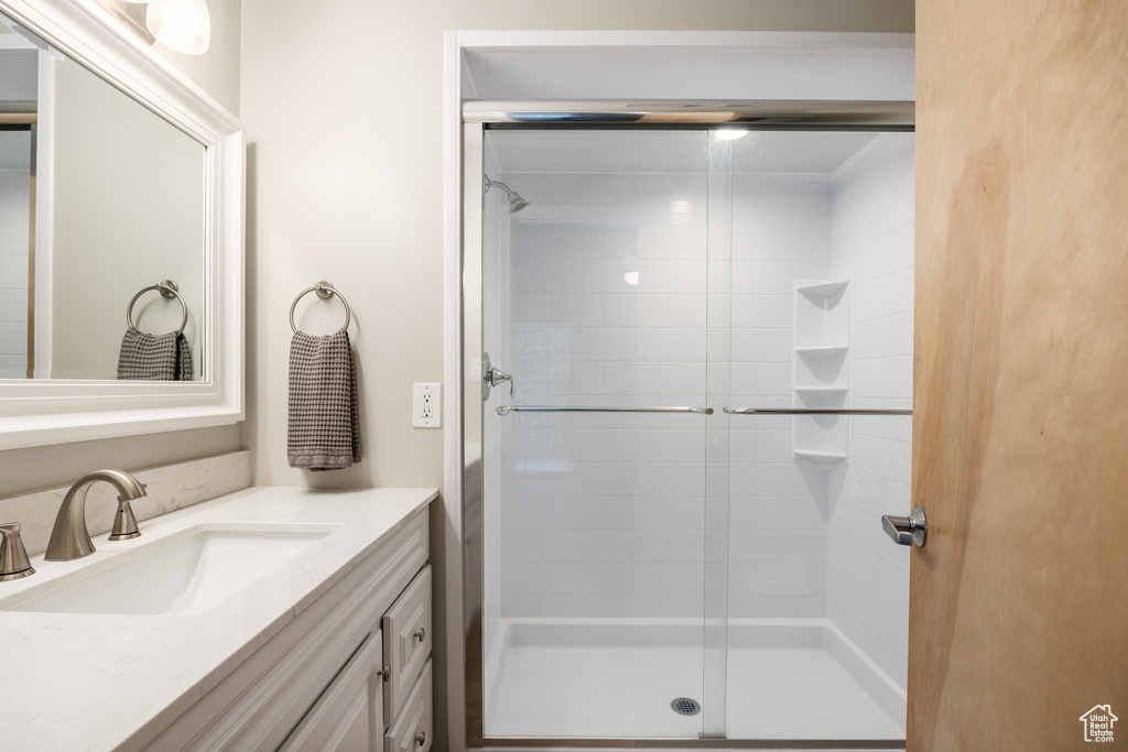 Bathroom featuring vanity and a stall shower