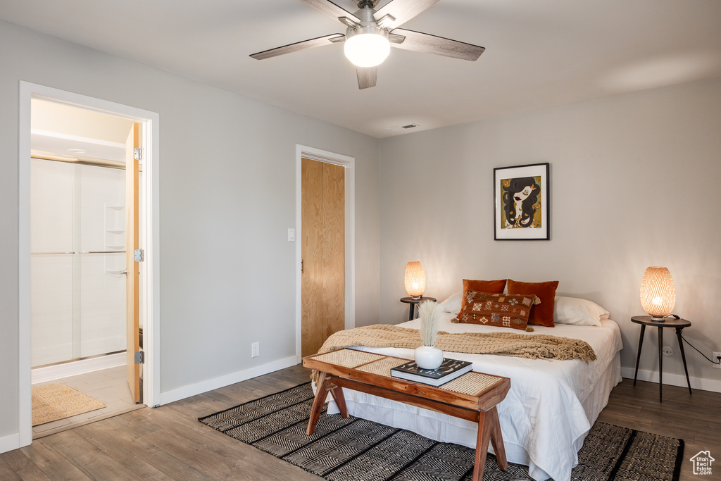 Bedroom featuring connected bathroom, baseboards, ceiling fan, and wood finished floors