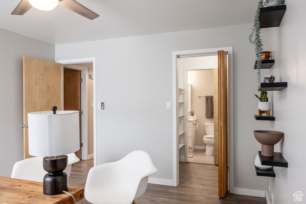 Living area with baseboards, ceiling fan, and wood finished floors