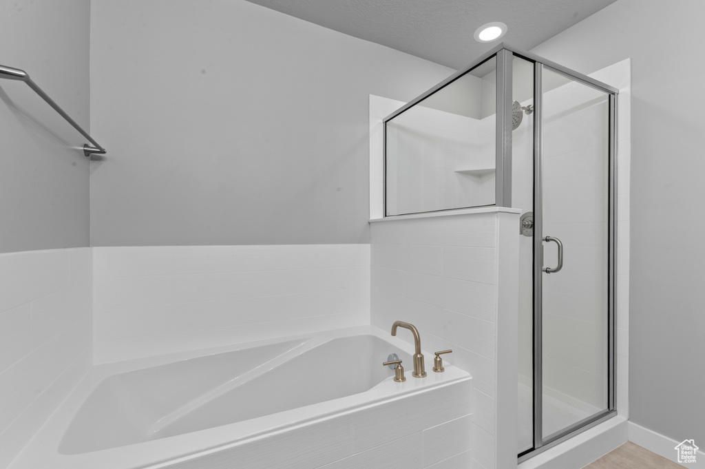 Full bath featuring a shower stall and a bath