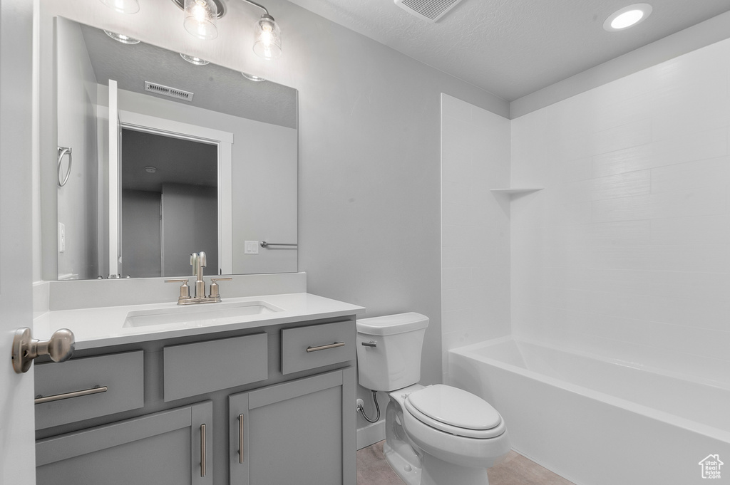 Bathroom with visible vents, shower / bathing tub combination, toilet, and vanity