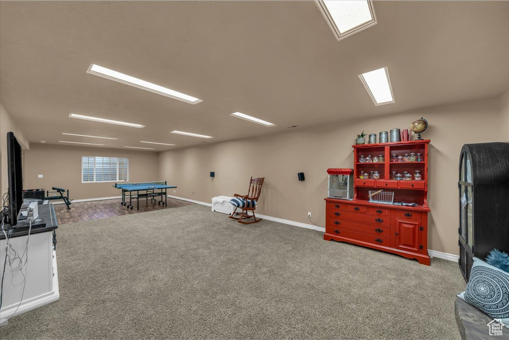 Recreation room with carpet floors and baseboards