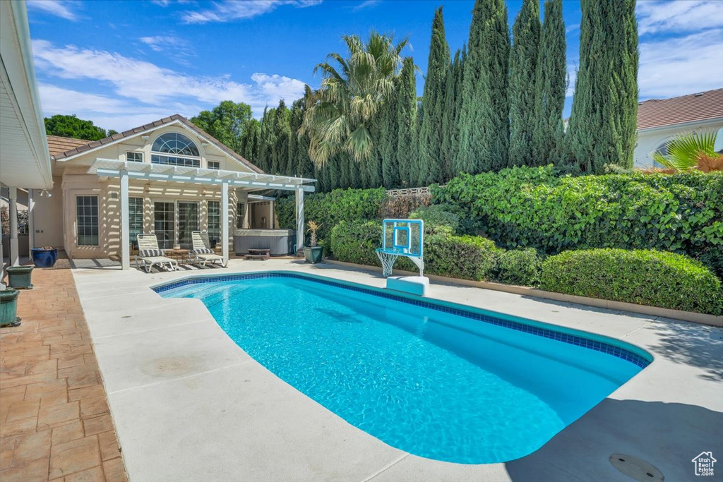 Outdoor pool with a pergola, a patio, and a jacuzzi
