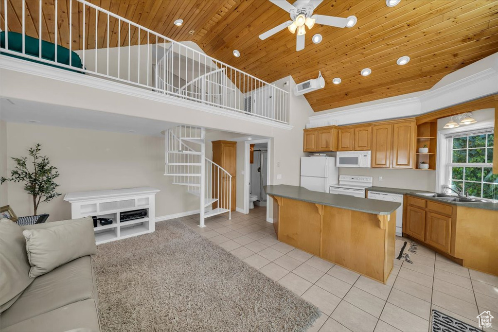 Kitchen featuring white appliances, high vaulted ceiling, a center island, wood ceiling, and light tile patterned floors