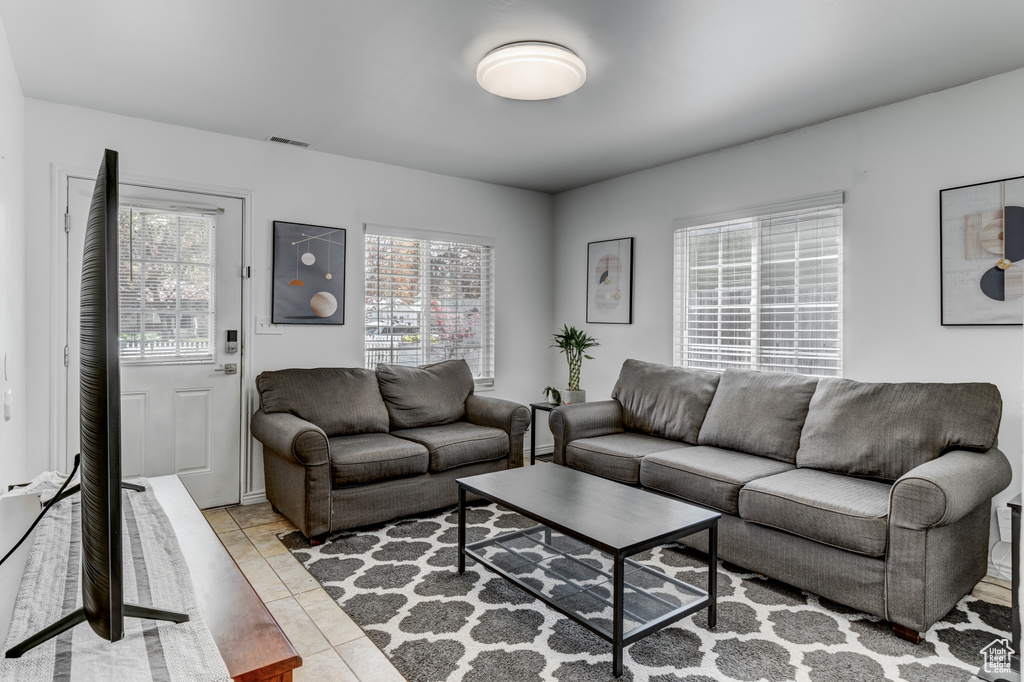 Living room with visible vents and tile patterned floors