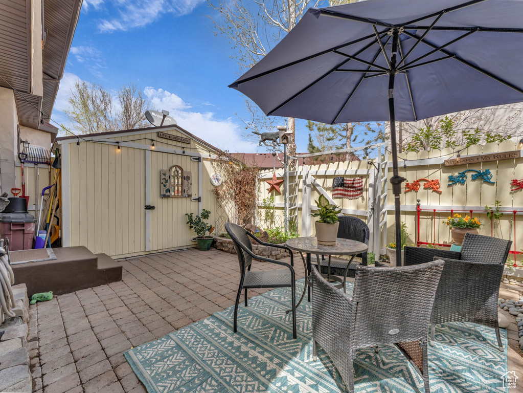 View of patio / terrace with outdoor dining area and an outdoor structure