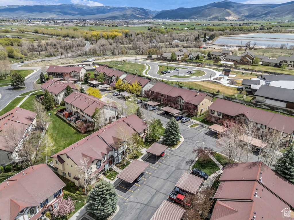 Birds eye view of property with a residential view and a water and mountain view