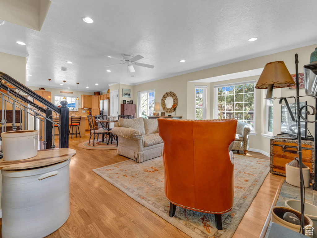 Living area featuring recessed lighting, a ceiling fan, and plenty of natural light