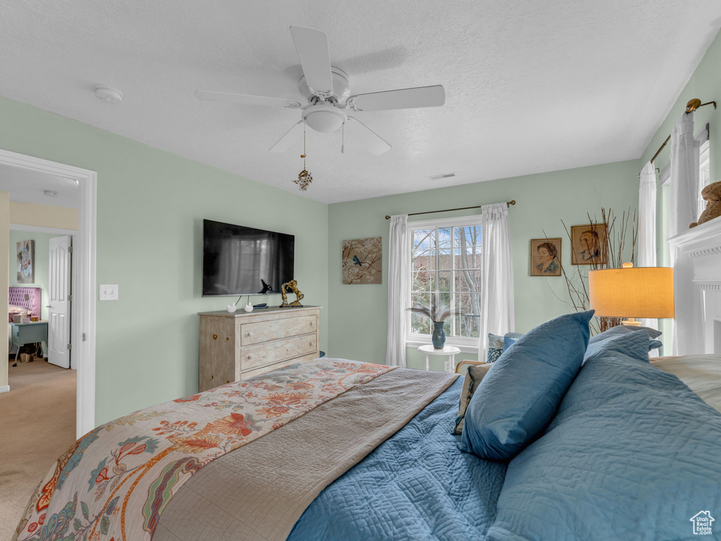 Bedroom with ceiling fan and carpet