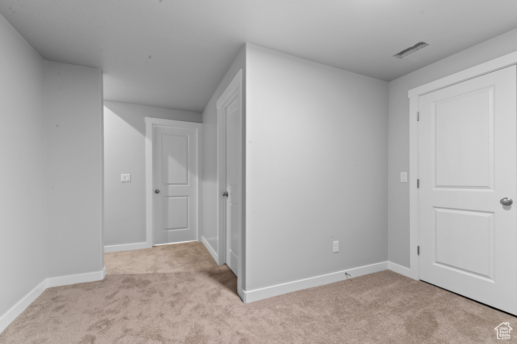 Interior space featuring carpet floors and baseboards